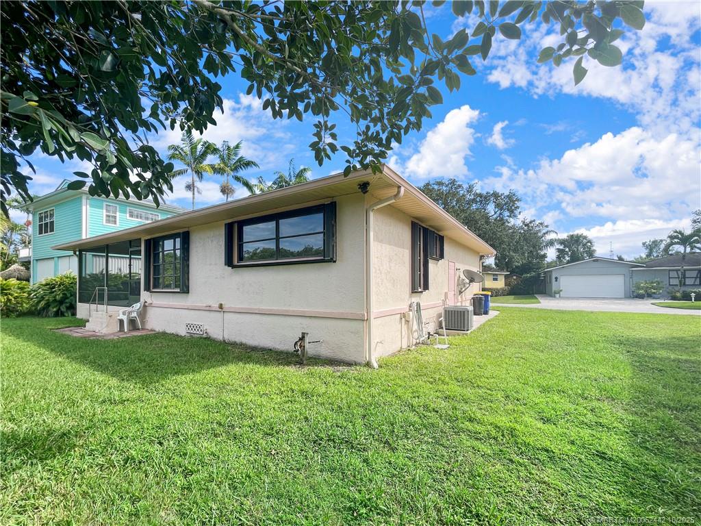 735 Southwest Salerno Road Stuart, FL 34997 - Photo 10 of 27 a view of a house with a yard