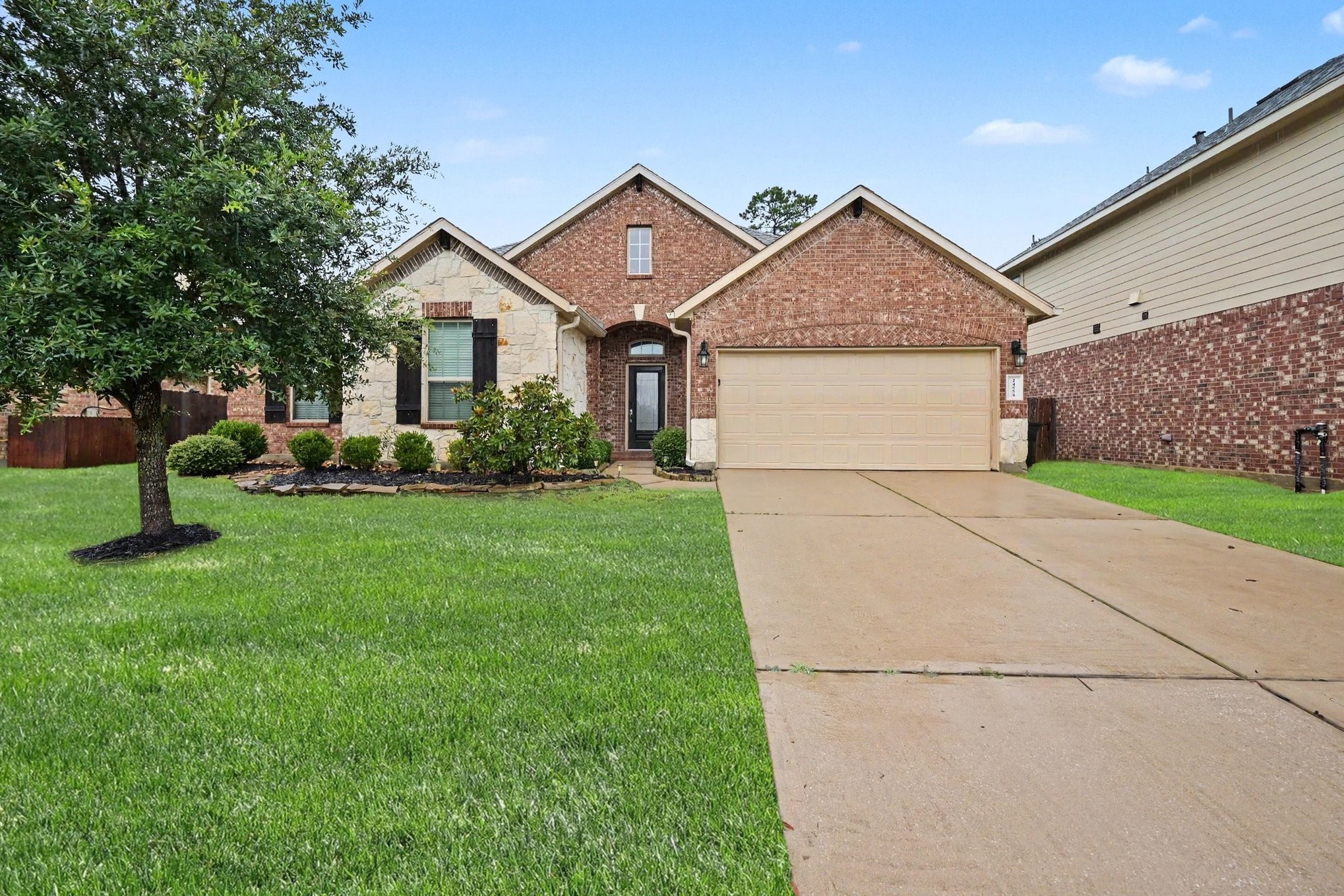 24554 Grayson Falls Lane Spring, TX 77389 - Photo 1 of 27 a view of a house with a big yard and large trees