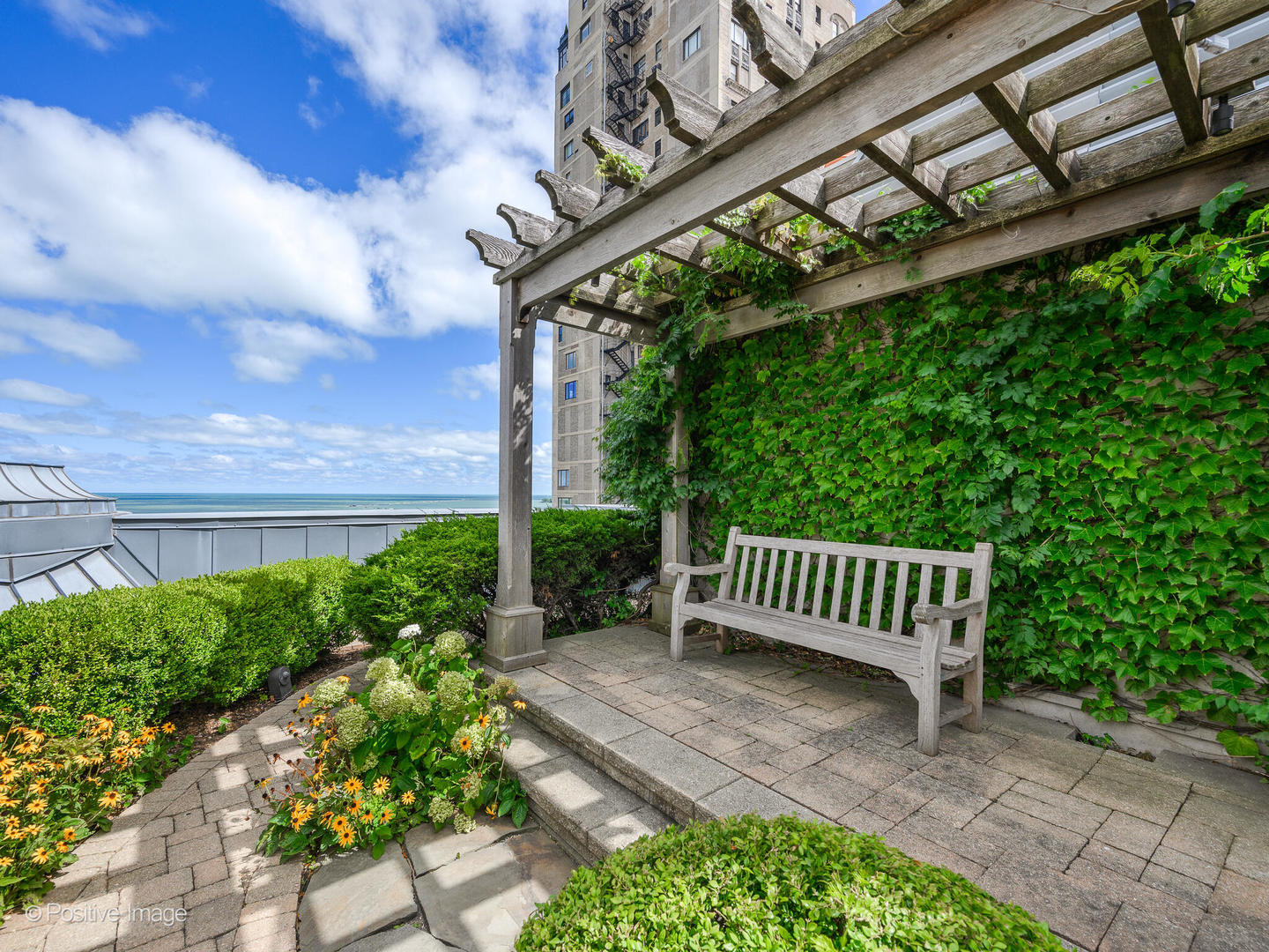 65 East Goethe Street, Unit 8N Chicago, IL 60610 - Photo 48 of 53 a view of a bench in patio with wooden fence
