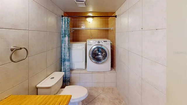 a bathroom with a granite countertop toilet sink and mirror