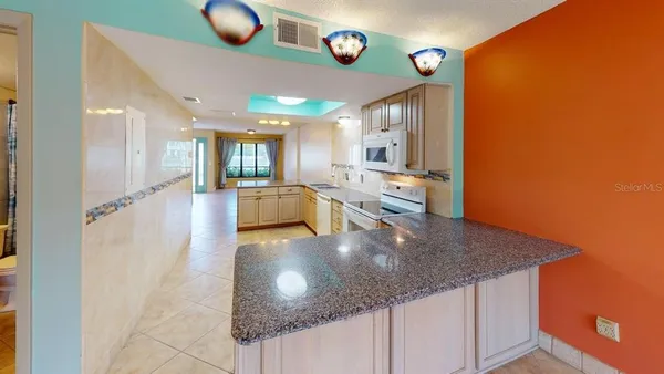 a view of a living room and kitchen