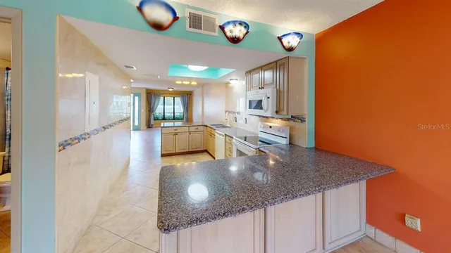 a view of a living room and kitchen