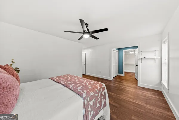 a view of a room with wooden floor and a window