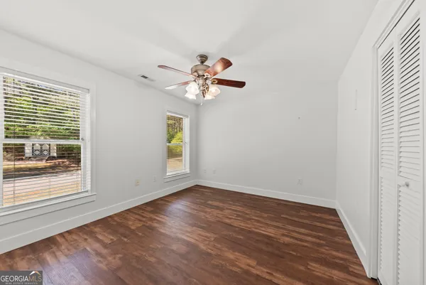 a view of an empty room with wooden floor