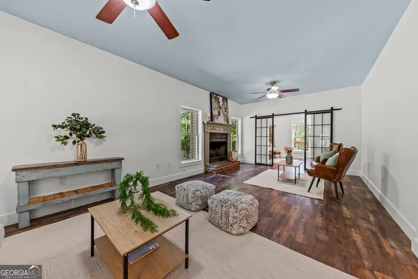 a living room with furniture couches and a potted plant