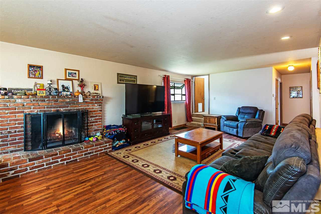 1400 Roberts Street Reno, NV 89502 - Photo 5 of 19 a living room with furniture a flat screen tv and a fireplace