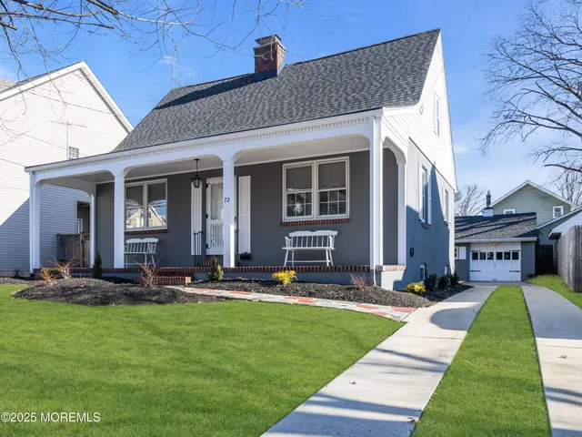a front view of a house with a yard table and chairs