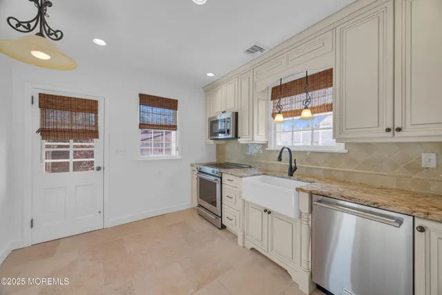 a kitchen with a sink stove and cabinets