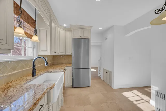 a kitchen with a refrigerator and a sink