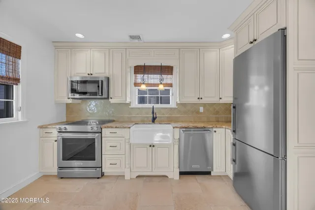 a kitchen with a stove sink and refrigerator