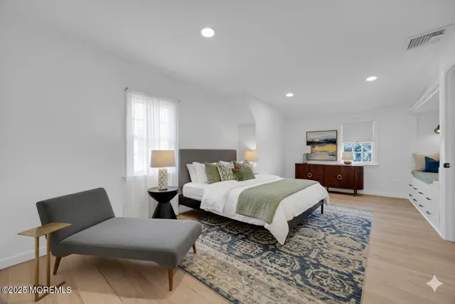 a bedroom with a bed and a view of kitchen