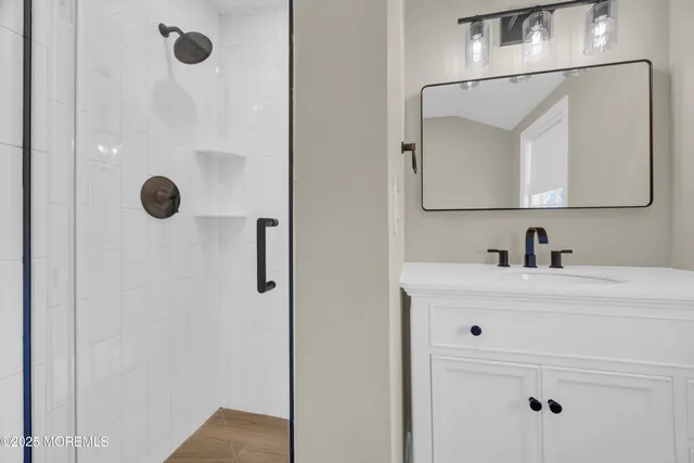 a bathroom with a sink vanity and mirror