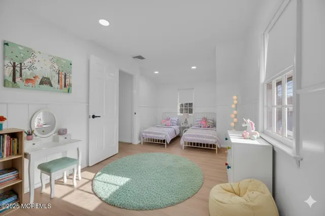 a spacious bedroom with a bed and furniture