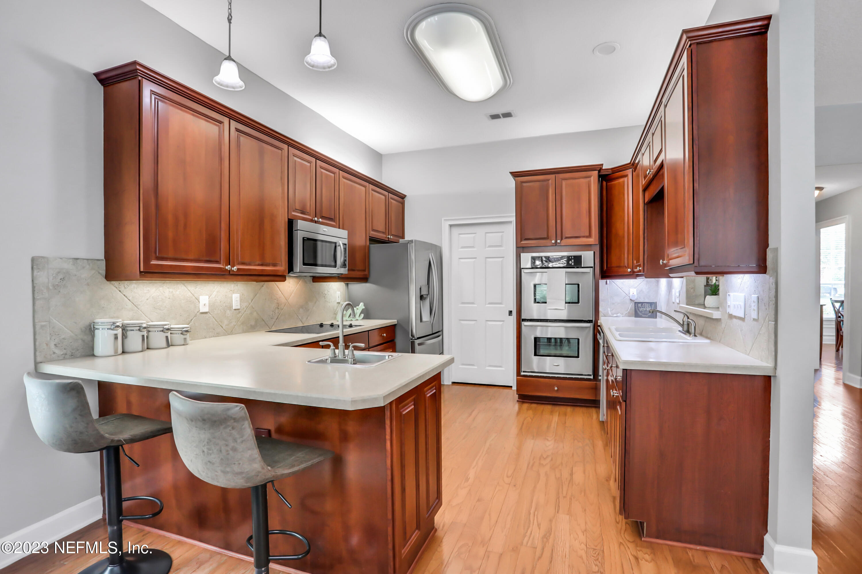 212 Twining Trace St. Johns, FL 32259 - Photo 12 of 60 a kitchen with stainless steel appliances granite countertop a sink dishwasher stove refrigerator and cabinets with wooden floor