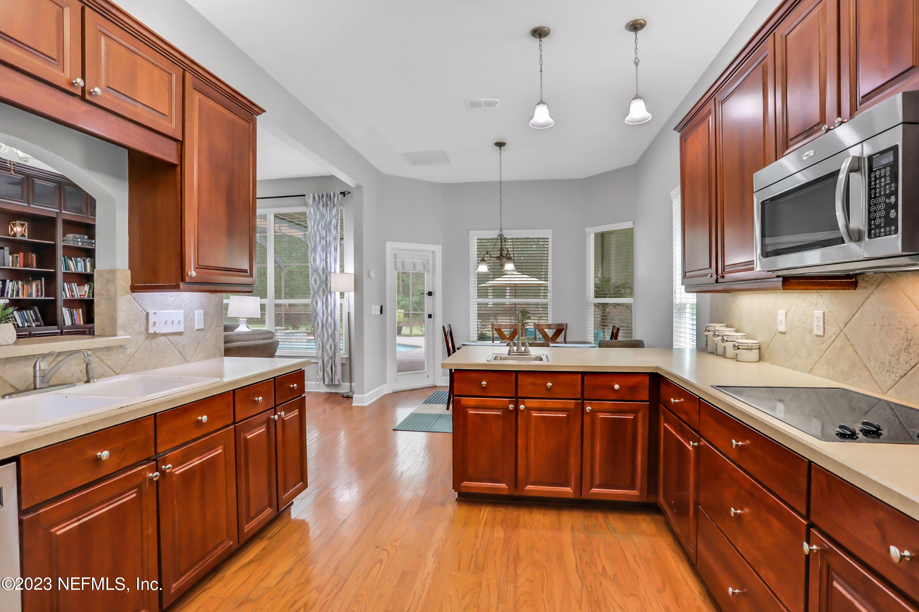 212 Twining Trace St. Johns, FL 32259 - Photo 13 of 60 a large kitchen with stainless steel appliances granite countertop a sink and wooden cabinets