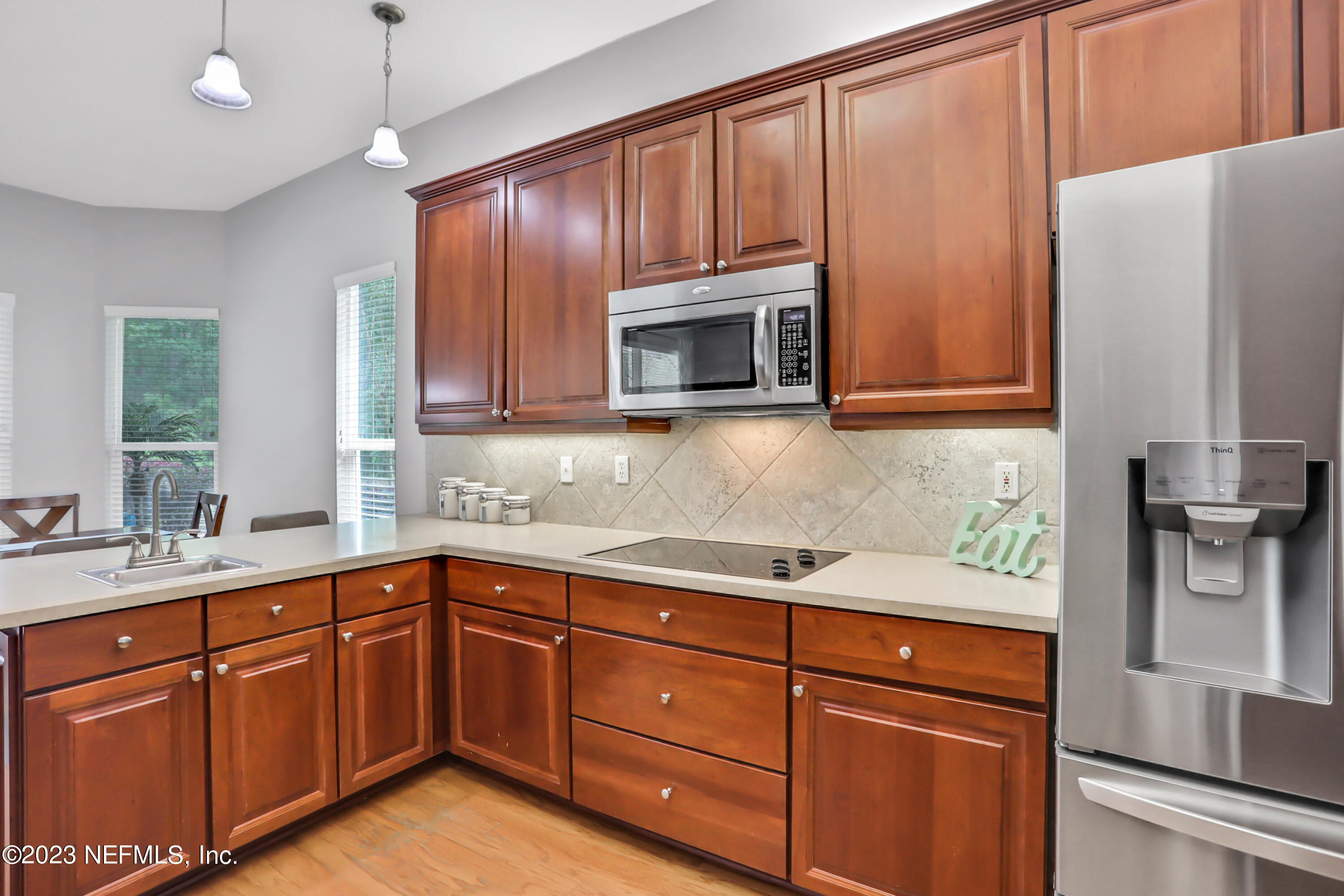 212 Twining Trace St. Johns, FL 32259 - Photo 14 of 60 a kitchen with stainless steel appliances granite countertop wooden cabinets a refrigerator and a sink