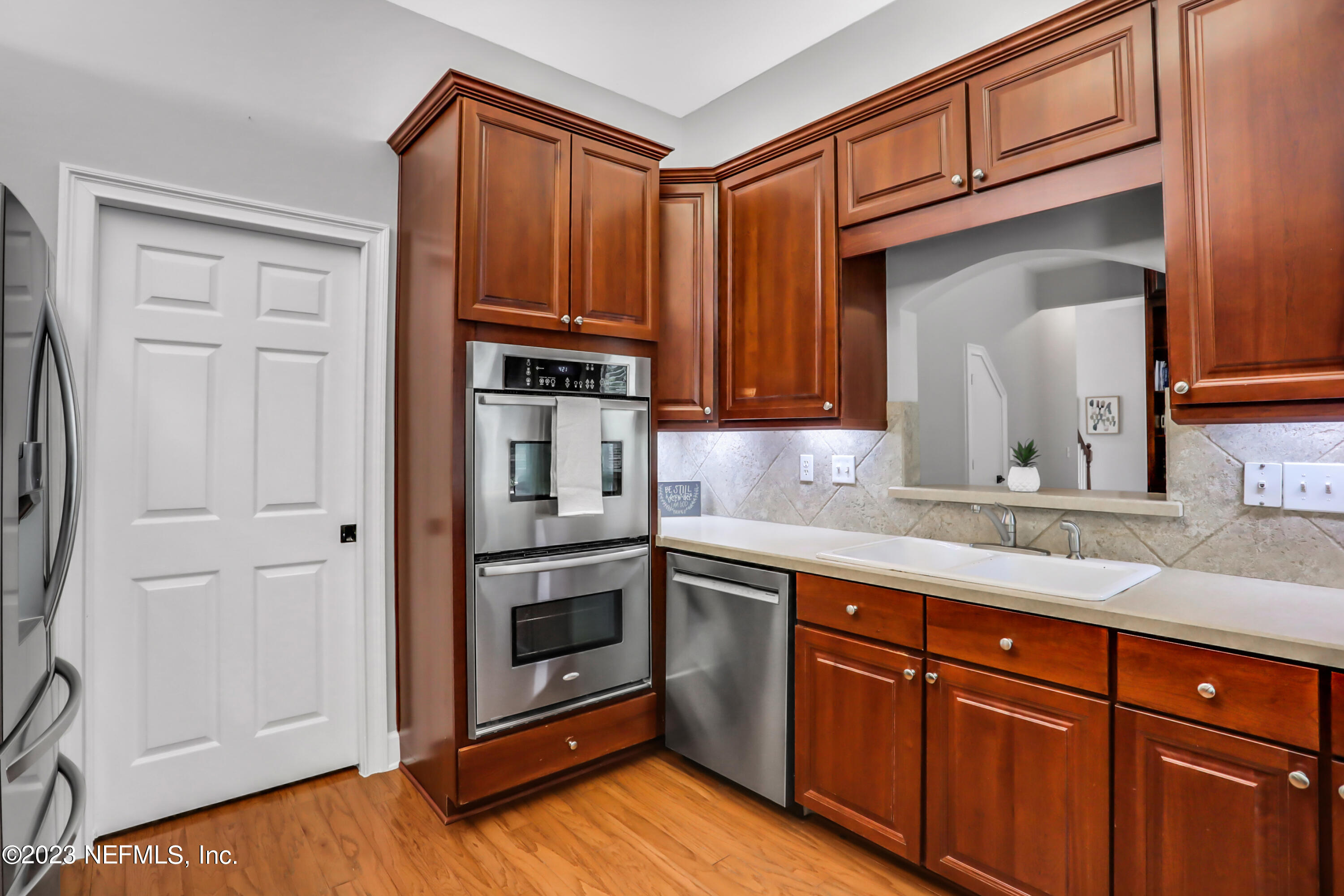 212 Twining Trace St. Johns, FL 32259 - Photo 15 of 60 a kitchen with stainless steel appliances granite countertop a sink and cabinets with wooden floor