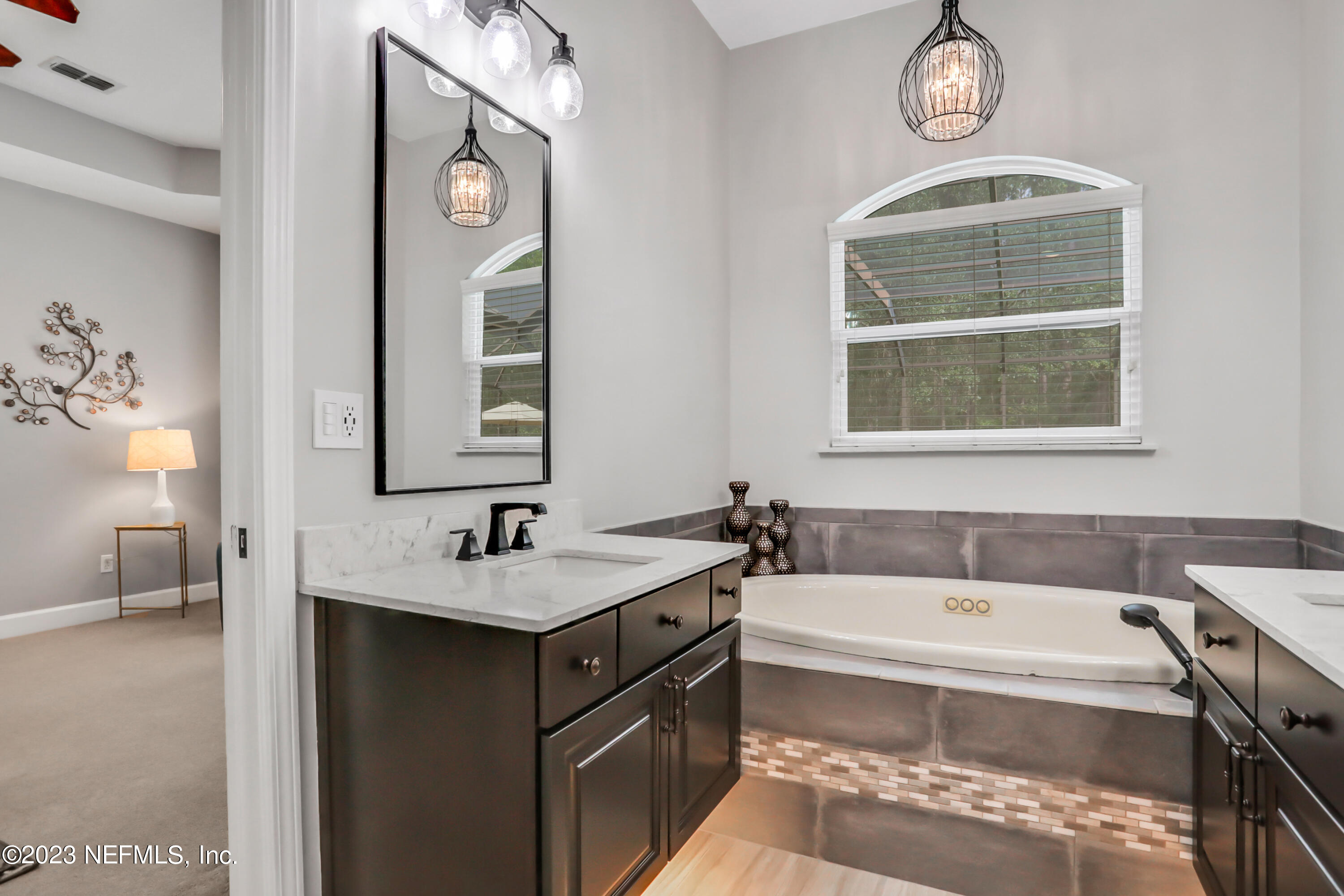 212 Twining Trace St. Johns, FL 32259 - Photo 23 of 60 a bathroom with a tub sink and mirror