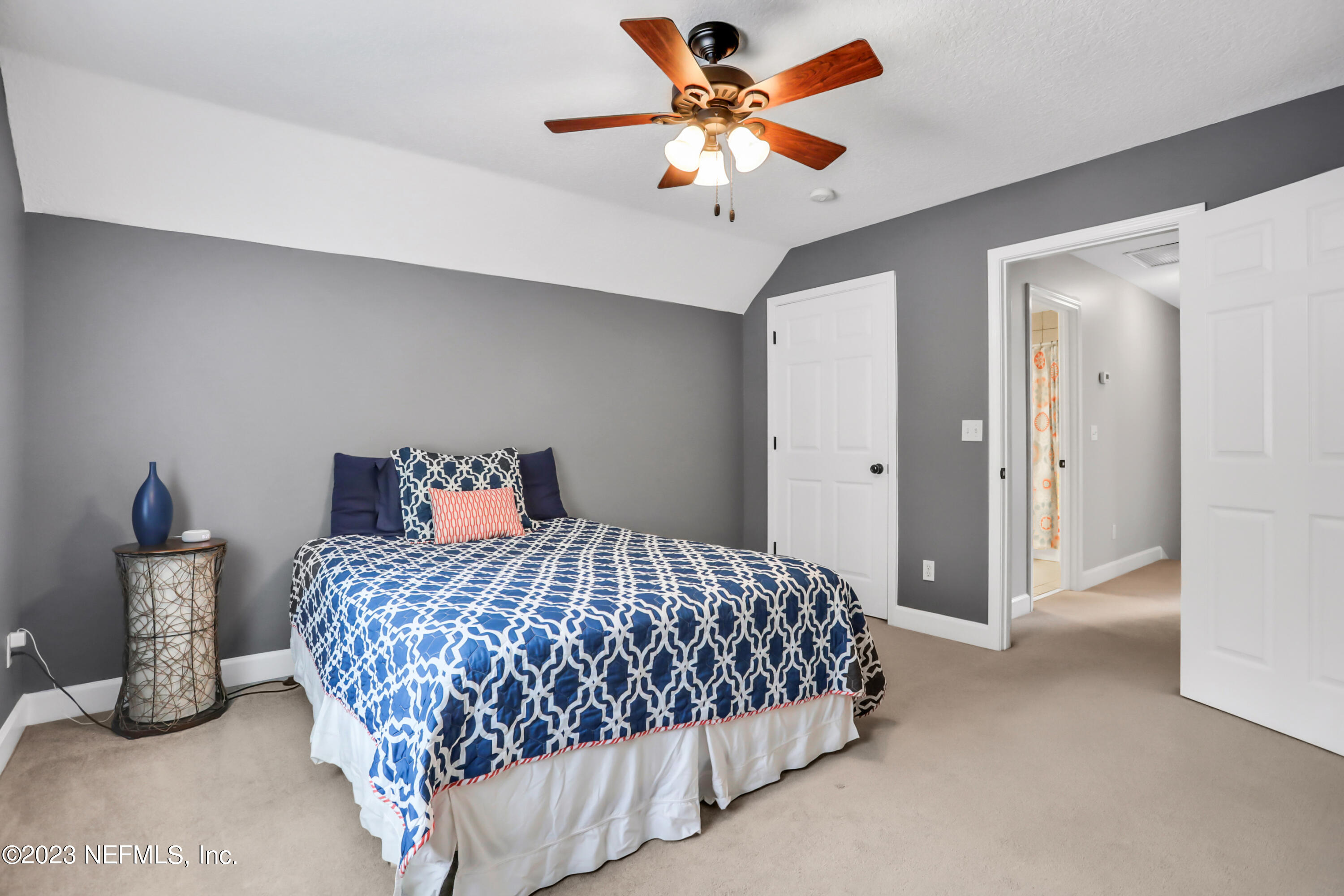 212 Twining Trace St. Johns, FL 32259 - Photo 27 of 60 a bedroom with a bed and a chandelier