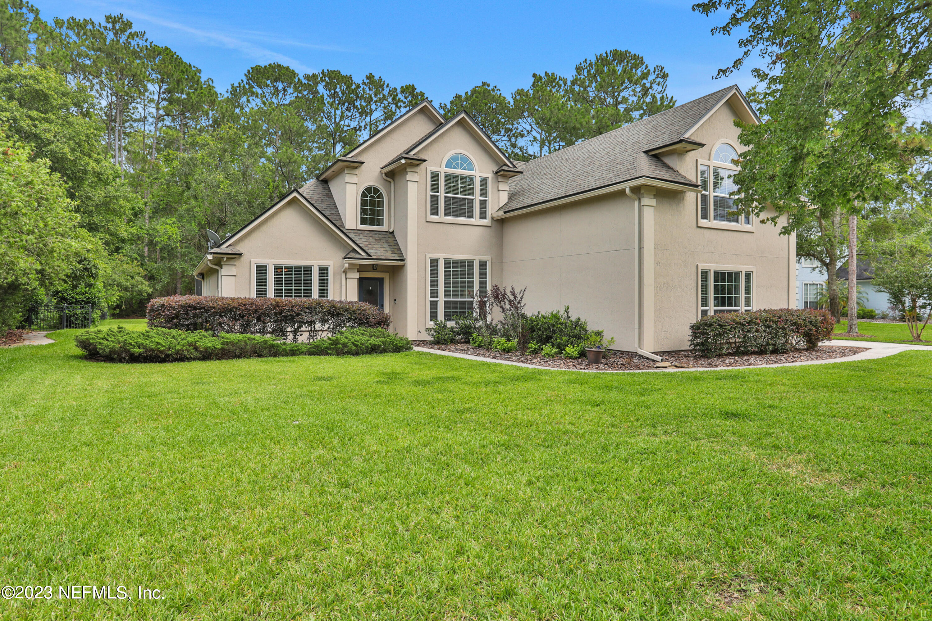 212 Twining Trace St. Johns, FL 32259 - Photo 42 of 60 a front view of a house with a garden and plants