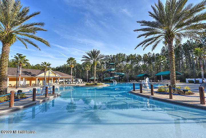 212 Twining Trace St. Johns, FL 32259 - Photo 45 of 60 a view of a swimming pool with a table and chairs
