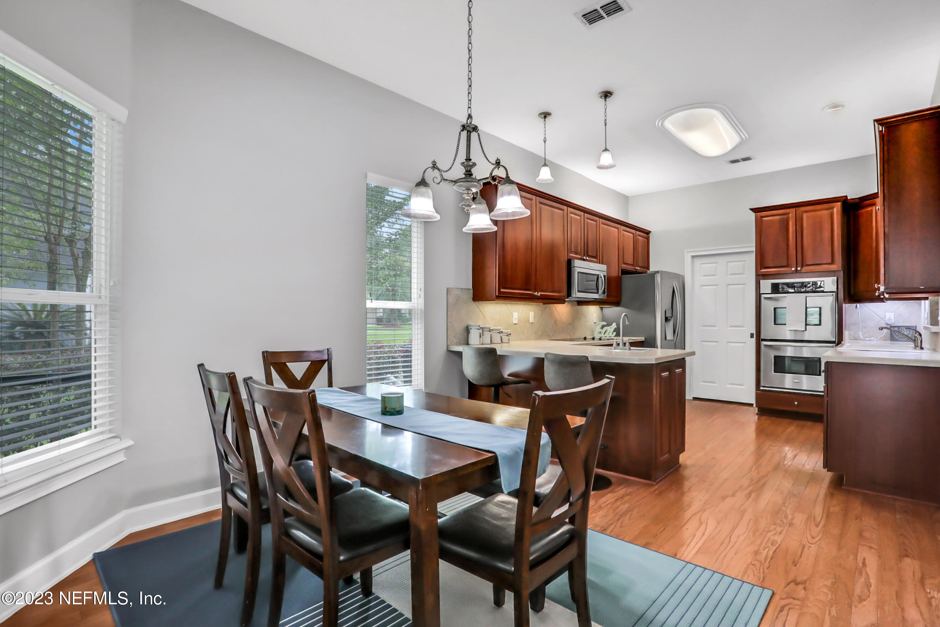 212 Twining Trace St. Johns, FL 32259 - Photo 10 of 60 a view of a dining room with furniture a kitchen and chandelier