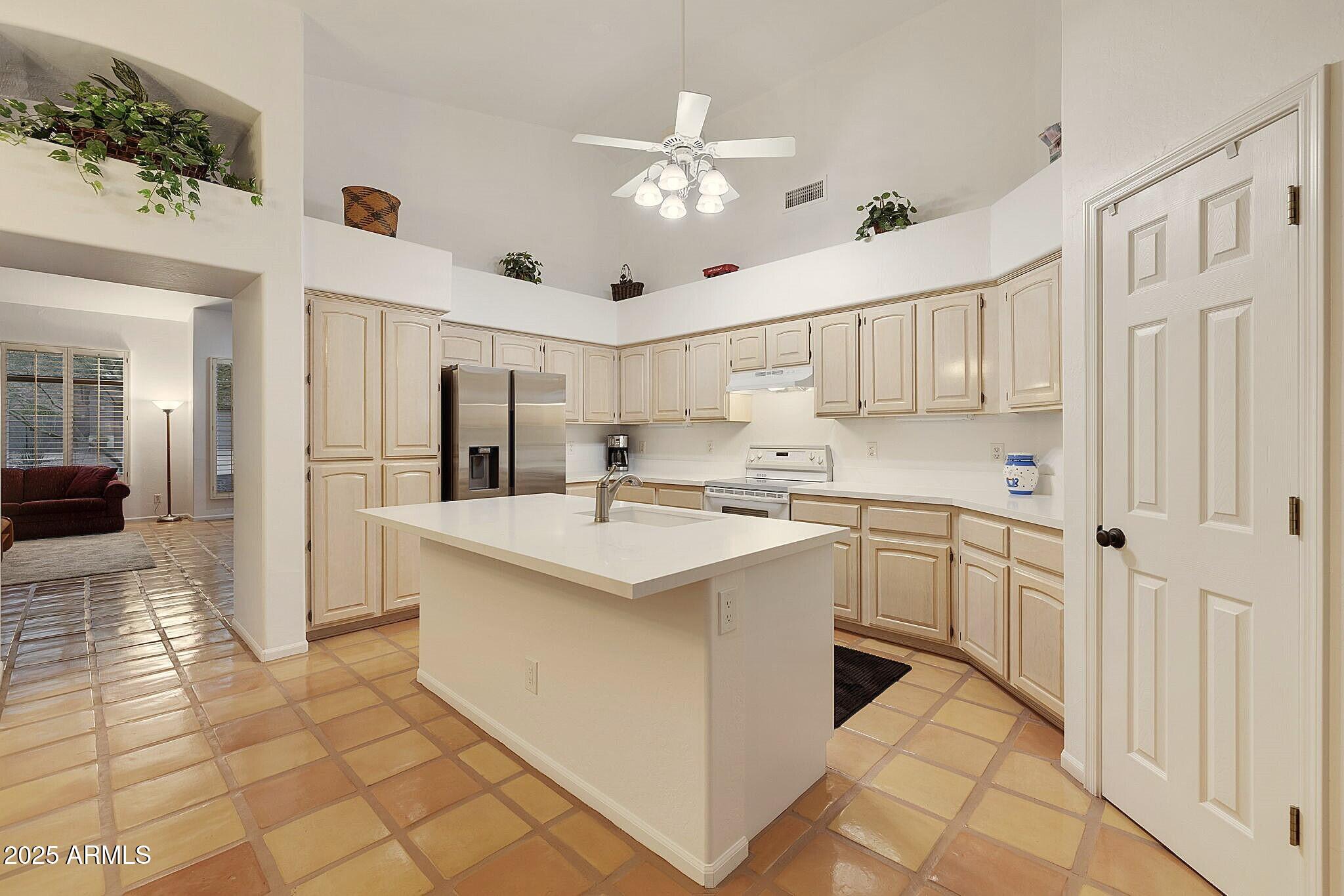 6334 East Viewmont Drive, Unit 57 Mesa, AZ 85215 - Photo 3 of 61 a kitchen with cabinets a sink a window and stainless steel appliances