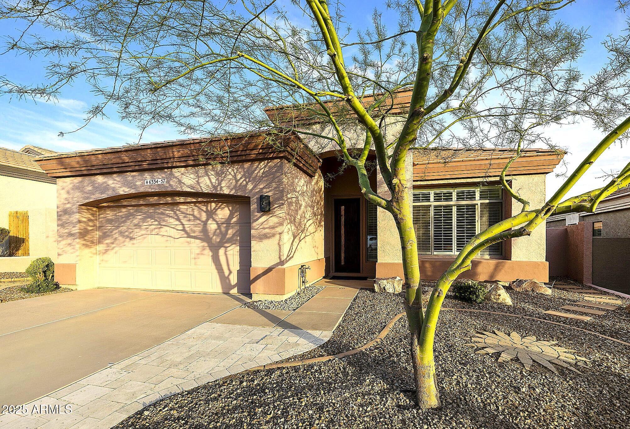 6334 East Viewmont Drive, Unit 57 Mesa, AZ 85215 - Photo 60 of 61 a view of a house with a tree in the background