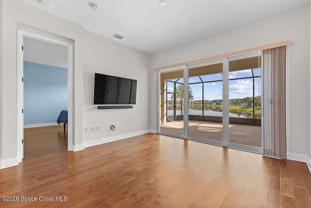 a view of kitchen with kitchen island stainless steel appliances wooden floor and view living room