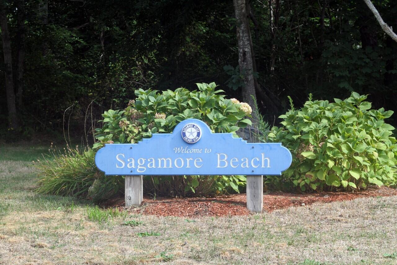 46 Diandy Road Sagamore Beach, MA 02562 - Photo 18 of 23 a wooden bench sitting in a backyard of a house
