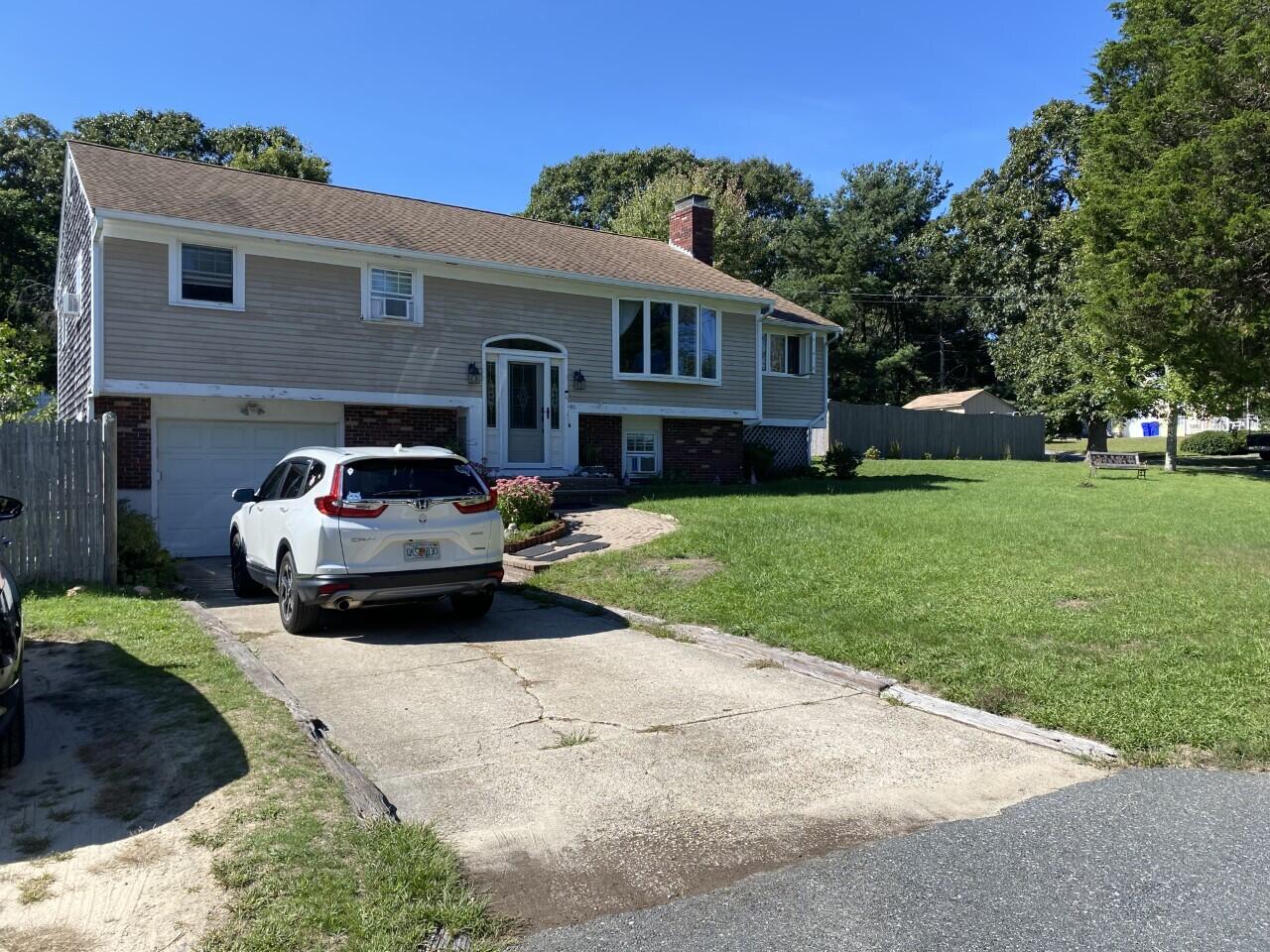 46 Diandy Road Sagamore Beach, MA 02562 - Photo 3 of 23 a car parked in front of a house with a yard