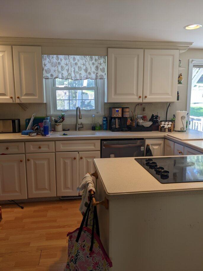 46 Diandy Road Sagamore Beach, MA 02562 - Photo 6 of 23 a kitchen with a sink a stove cabinets and a window