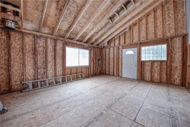 a view of an empty room with windows