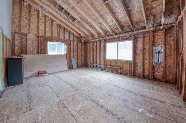 a view of a livingroom with an empty space and a window