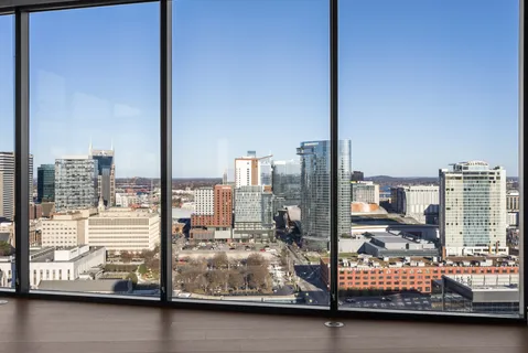 a kitchen with stainless steel appliances granite countertop a refrigerator a sink dishwasher a stove and a refrigerator with wooden floor