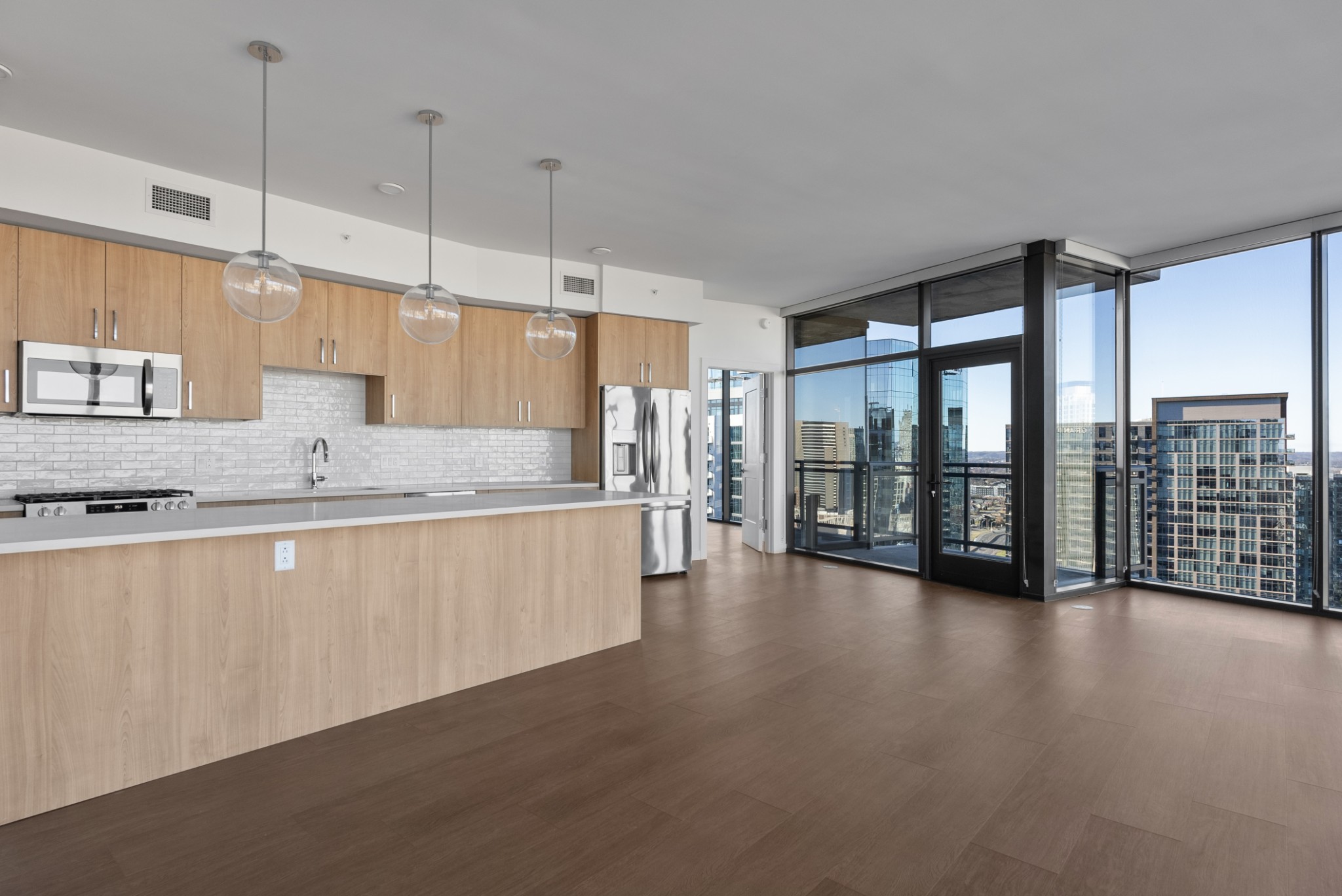 1212 Demonbreun Street, Unit C3D(K) Nashville, TN 37203 - Photo 6 of 33 a large kitchen with stainless steel appliances granite countertop a large window and a wooden floors