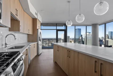 a view of an empty room window and a wooden floor