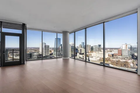 a view of workspace with floor to ceiling window and wooden floor