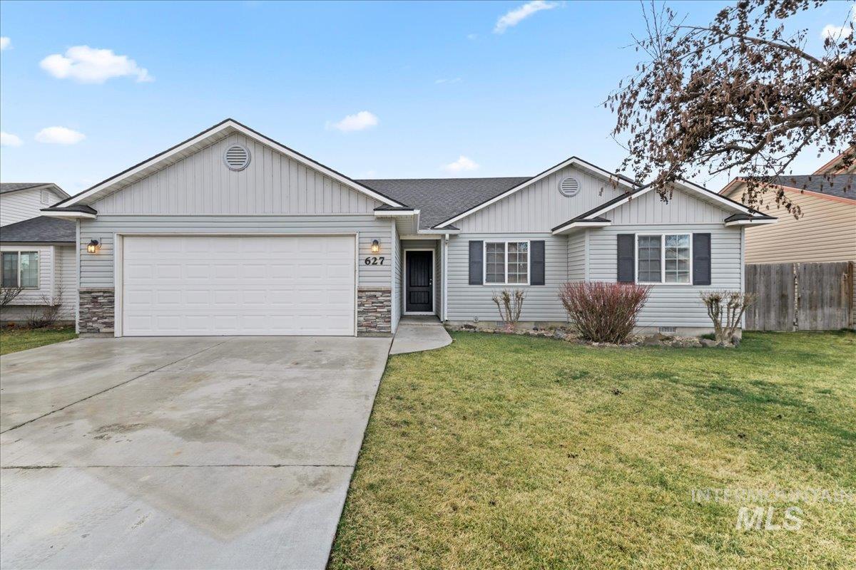 Single story home with stone siding, board and batten siding, concrete driveway, a garage, and a shingled roof