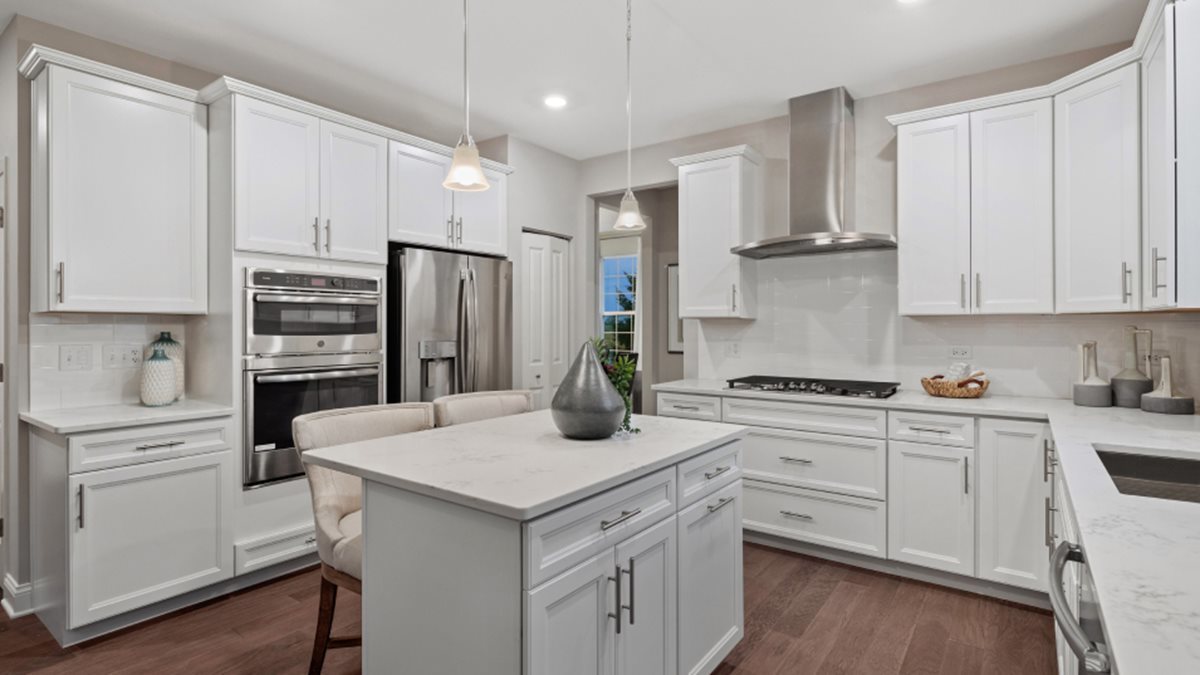 229 Bowers Street Elburn, IL 60119 - Photo 4 of 11 a kitchen with white cabinets and stainless steel appliances