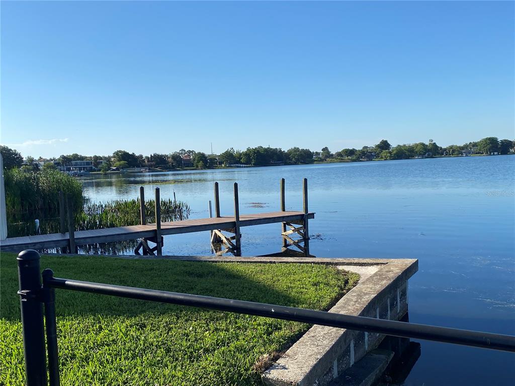 1500 Gay Road, Unit 17D Winter Park, FL 32789 - Photo 31 of 34 a view of a lake with couches and wooden fence