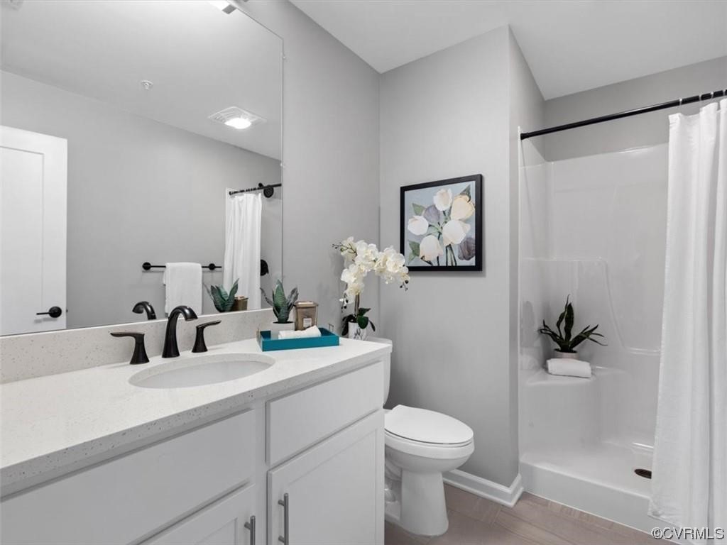 1504 Ewing Park Loop, Unit 205 Midlothian, VA 23113 - Photo 16 of 26 a bathroom with a toilet sink and mirror