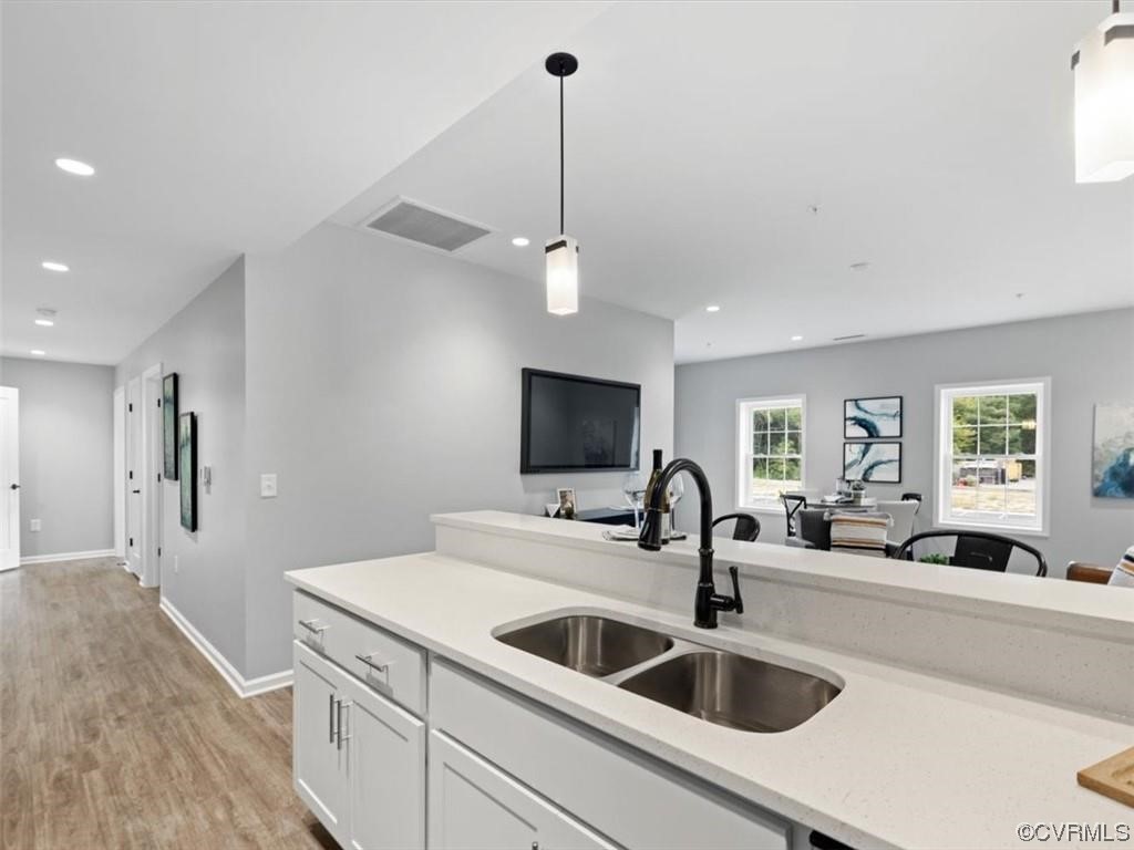 1504 Ewing Park Loop, Unit 205 Midlothian, VA 23113 - Photo 6 of 26 a kitchen with a sink and a refrigerator