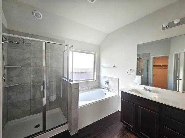 a bathroom with a double vanity sink mirror and shower
