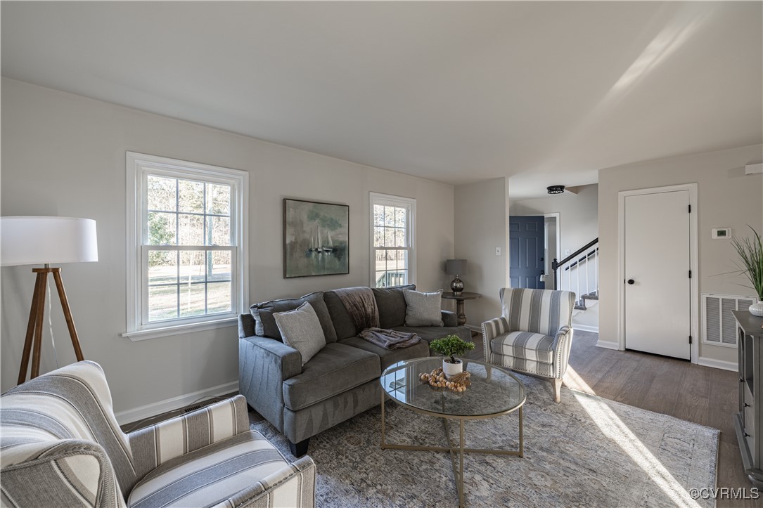 5501 West Quaker Road Disputanta, VA 23842 - Photo 11 of 26 Living room with dark wood-style floors, stairs, v
