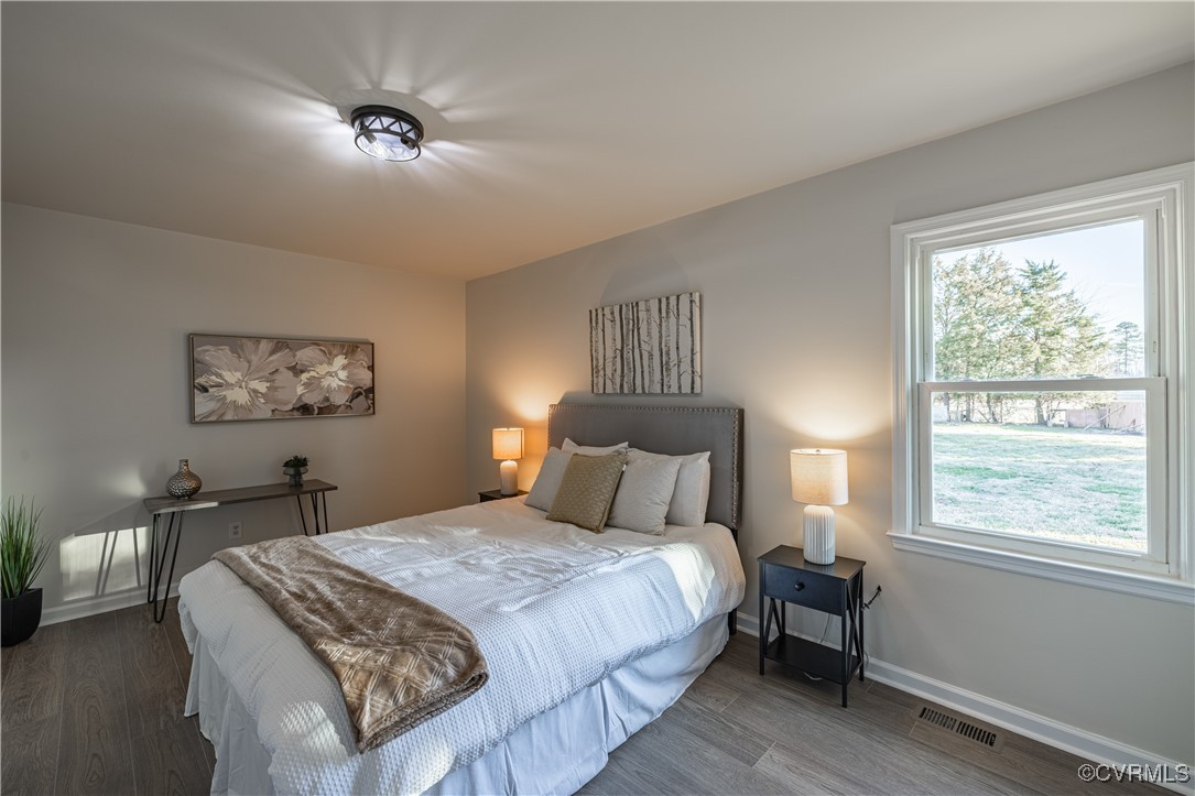 5501 West Quaker Road Disputanta, VA 23842 - Photo 20 of 26 Bedroom with wood finished floors, visible vents,
