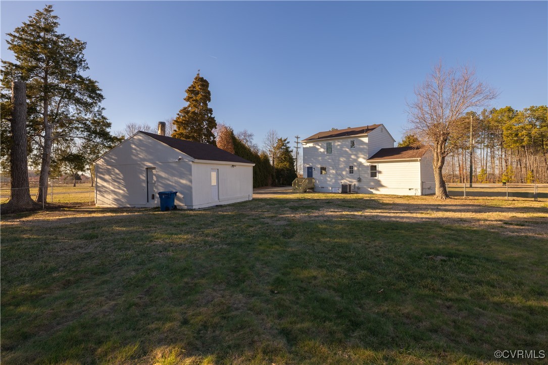 5501 West Quaker Road Disputanta, VA 23842 - Photo 7 of 26 View of yard featuring an outbuilding and fence