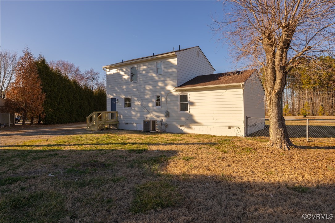 5501 West Quaker Road Disputanta, VA 23842 - Photo 8 of 26 View of home's exterior with a yard, central AC un