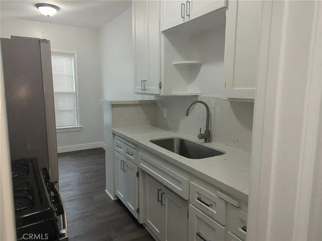 a kitchen with a sink and cabinets