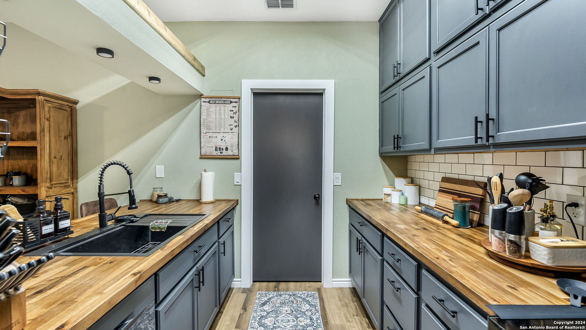 7935 Sonny Ridge San Antonio, TX 78244 - Photo 8 of 22 a kitchen with stainless steel appliances granite countertop a sink stove and cabinets